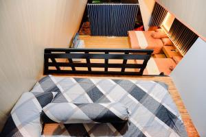 a room with a staircase with a bed in it at Villa Kebon Paman in Balong