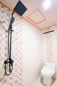 a shower in a bathroom with a toilet at Villa Kebon Paman in Balong