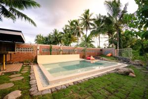 a swimming pool in the yard of a house at Villa Kebon Paman in Balong