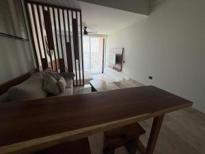 a living room with a table and a couch at Beach Studio Playa del Carmen MX in Playa del Carmen
