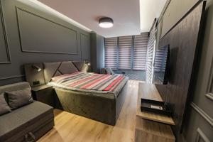 a small bedroom with a bed and a couch at Villa Sveti Gorgi in Ohrid
