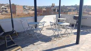 a patio with chairs and tables on a roof at AG Dusty Luxe Suite #3 in San Miguel de Allende +3 photos