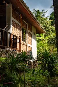 a house with a porch and a balcony at Zen Forest in Ko Phangan