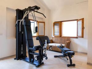a living room with a gym with two tread machines at Studio for couples in Capo Vaticano with pool in Capo Vaticano
