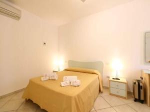 a bedroom with a bed with two towels on it at Studio for couples in Capo Vaticano with pool in Capo Vaticano +14 photos