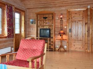 a living room with a chair and a television at 4 person holiday home in olden in Olden