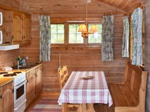 a kitchen with a table in a log cabin at 4 person holiday home in olden in Olden +10 photos