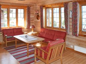 a living room with a red couch and a table at 6 person holiday home in olden in Olden