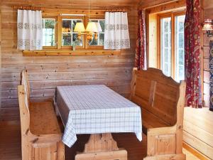 a room with a table and chairs in a cabin at 5 person holiday home in olden in Olden