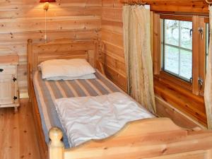 a bedroom with two beds in a log cabin at 5 person holiday home in olden in Olden
