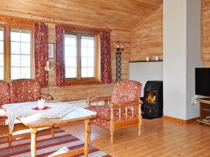 a living room with a table and a fireplace at 5 person holiday home in olden in Olden