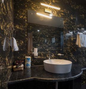 a bathroom with a sink and a mirror at Jambayang Resort in Thimphu +32 photos