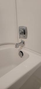 a bathroom sink with a faucet on a counter at Neepawa Motel in Neepawa