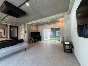 a living room with a couch and a table at Guesthouse Matsu 別館 in Osaka