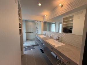 a bathroom with two sinks and a shower at Guesthouse Matsu 別館 in Osaka +86 photos