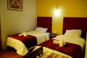 a hotel room with two beds with towels on them at Misti Hostel B&B in Arequipa +21 photos