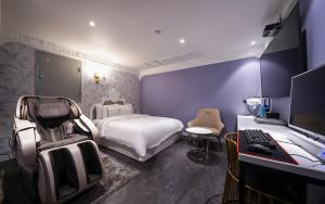 a bedroom with a bed and a desk with a computer at MARI hotel in Incheon