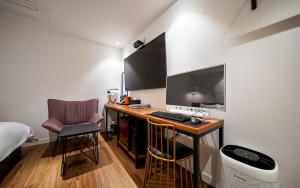 a room with a desk with a computer and a chair at MARI hotel in Incheon