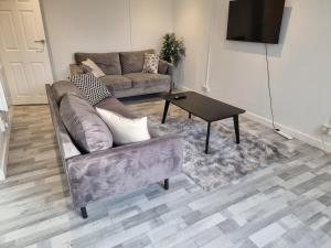 a living room with a couch and a coffee table at Away Home in London