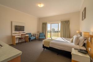 a hotel room with a bed and a desk at Eagle Heights Mountain Resort in Eagle Heights