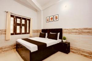 a bedroom with a large bed and a window at Hotel HP Palace in Gorakhpur +17 photos