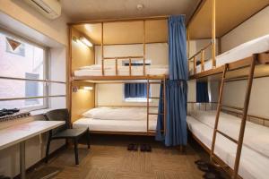 a dorm room with bunk beds and a desk at Sakura Hotel Jimbocho in Tokyo +68 photos