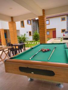 a pool table with two cuesticks on top of it at Villa Campo Verde in Jarabacoa