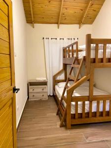 a bedroom with two bunk beds and a door at Villa Campo Verde in Jarabacoa +22 photos
