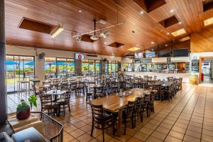 a restaurant with wooden ceilings and tables and chairs at Eagle Heights Mountain Resort in Eagle Heights