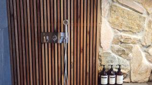 a shower with bottles of beer sitting next to a stone wall at Myeongwolga Poolvilla in Busan +42 photos