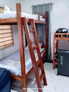 a pair of bunk beds in a room at Chief's Villa Malapascua Island Dorm with Hot Shower & Outdoor Kitchenette in Malapascua Island