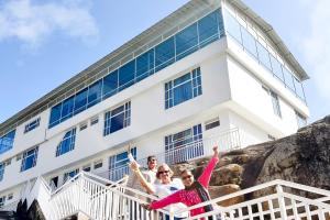 three people standing in front of a building at Hotel Alta Montaña Mongui By Seres Viajeros in Monguí