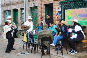 a group of people playing music on a street at Hotel Alta Montaña Mongui By Seres Viajeros in Monguí +20 photos
