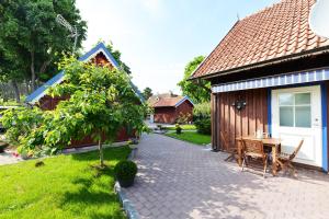 a patio with a table and a house at Lana in Nida