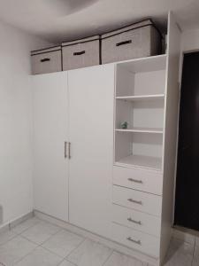 a white closet with white cabinets in a room at Casa centrica in Hermosillo