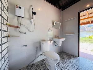 a bathroom with a toilet and a sink at KuangSi Resort in Luang Prabang +17 photos