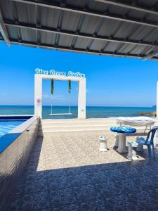 a swimming pool with a sign that reads the ocean station at 爱上海蓝蓝屋民宿 Blue Ocean Station in Penampang