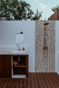 a bathroom with a sink and a shower at Lodge des palmiers - jacuzzi in Salazie +32 photos