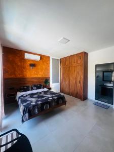 a large bedroom with a bed and a kitchen at Cloudview Villa in Mahébourg +10 photos