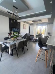 a dining room and living room with a table and chairs at Cloudview Villa in Mahébourg