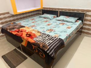 a bed with two pillows on it in a room at Shri Nimbark Mohini Kunj in Vrindāvan +8 photos