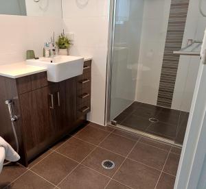 a bathroom with a sink and a shower at Executive King Suite - Ensuite in Holmview