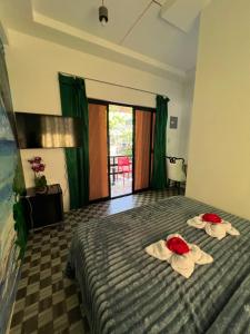 a hotel room with a bed with towels on it at Dutch Guest House Studio in Siquijor