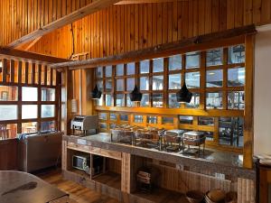 a kitchen with a counter with a bunch of stools at Jambayang Resort in Thimphu