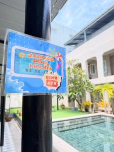 a sign on a pole next to a swimming pool at The Light House at Town Phuket in Phuket +6 photos