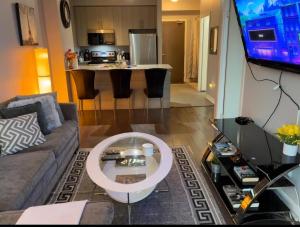 a living room with a couch and a table at Spacious-Cozy 2Bed Condo in Square Ones Misissauga in Mississauga +8 photos