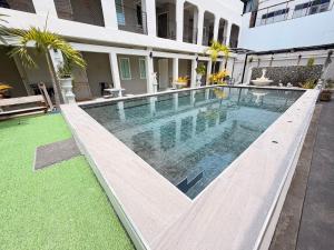a swimming pool in front of a building at The Light House at Town Phuket in Phuket