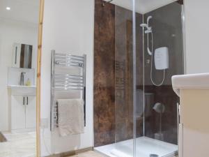 a bathroom with a shower and a sink at Bramble Cottage in Leven +4 photos