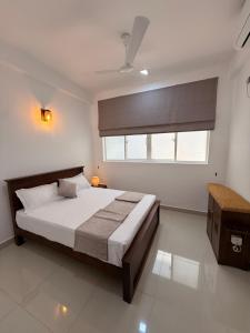 a bedroom with a large bed and a window at 2BR luxury Apartment in Mount Lavinia - Benetia Stay in Mount Lavinia