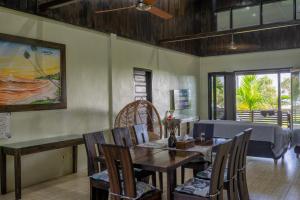 a dining room with a table and chairs at Island Time Surf Resort in Lasikin